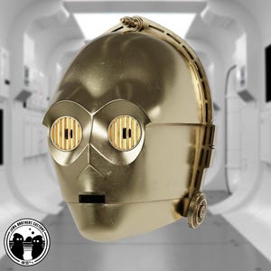 May include: A golden-colored C-3PO head replica, featuring detailed mechanical elements. The eyes have a grid-like pattern, and the head has a smooth, metallic finish. The Jawa Brothers Customs logo is visible at the bottom left.