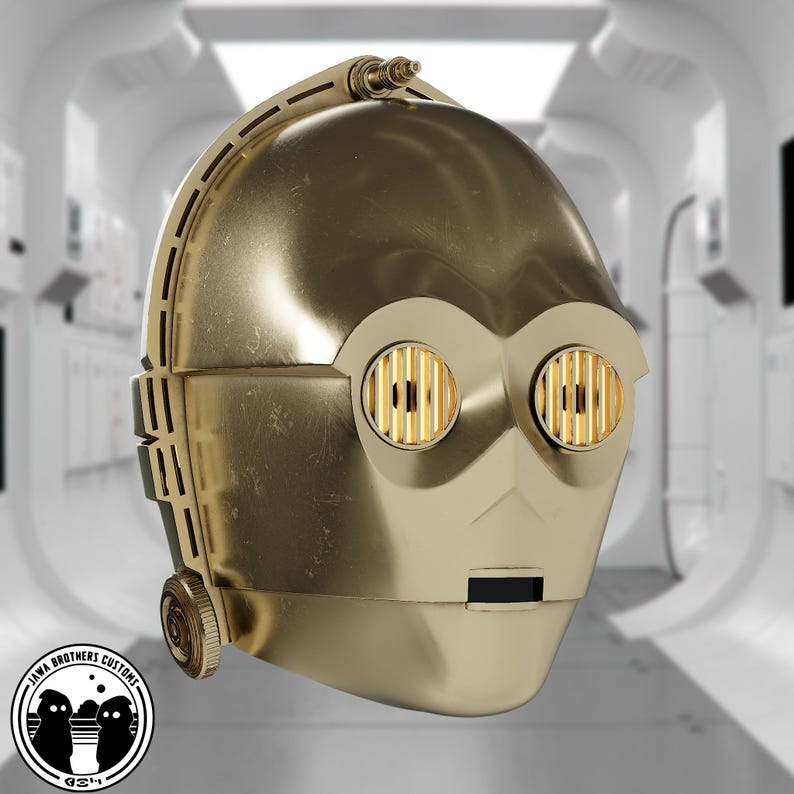 May include: A gold-colored C-3PO head replica, featuring detailed mechanical elements and circular eye designs. The head has a metallic finish and is set against a blurred, futuristic background. The Jawa Brothers Customs logo is visible in the lower left corner.