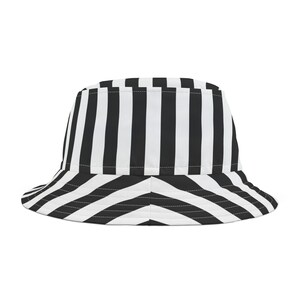 May include: A black and white striped bucket hat with a chevron pattern on the brim.