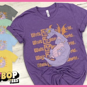 May include: Purple t-shirt with a cartoon purple dragon and the text "Walt Disney World" repeated five times in orange.