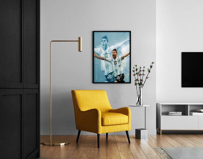 May include: A framed poster of a soccer player in a white jersey with the number 10 on it, celebrating a goal. The poster is hanging on a white wall above a yellow armchair in a living room.