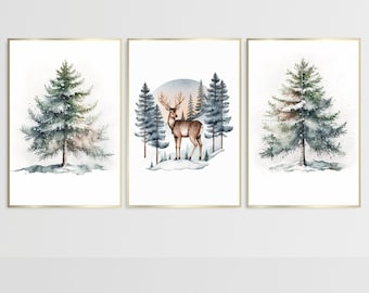 May include: Three watercolor paintings in gold frames. The left and right paintings feature a single snow-covered pine tree. The center painting features a deer standing in a snowy forest with a sunset in the background.