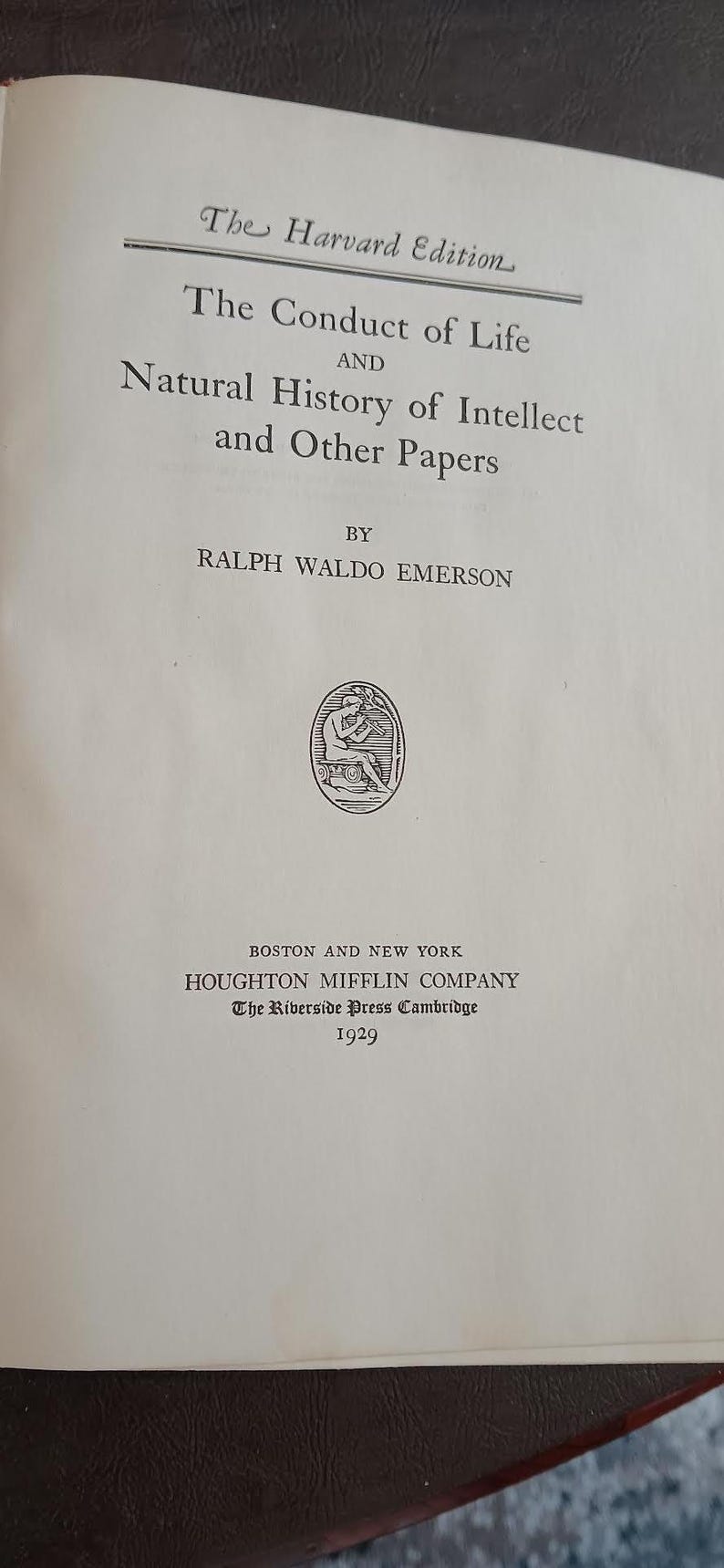 May include: An open book displaying the title "The Conduct of Life and Natural History of Intellect and Other Papers" by Ralph Waldo Emerson. Published by Houghton Mifflin Company in 1929. The Harvard Edition is printed at the top.