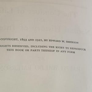 May include: A close-up of a book page with printed text. The text includes the copyright information: "COPYRIGHT, 1893 AND 1921, BY EDWARD W. EMERSON." Additional text states "RIGHTS RESERVED, INCLUDING THE RIGHT TO REPRODUCE THIS BOOK OR PARTS THEREOF IN ANY FORM."