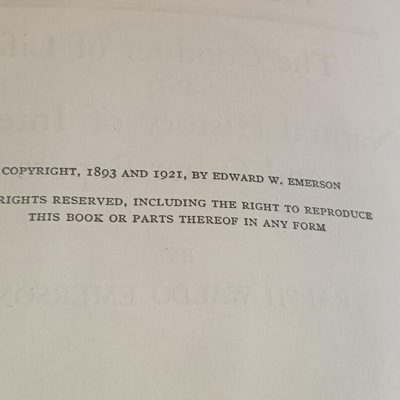 May include: A close-up of a book page with printed text. The text includes the copyright information: "COPYRIGHT, 1893 AND 1921, BY EDWARD W. EMERSON." Additional text states "RIGHTS RESERVED, INCLUDING THE RIGHT TO REPRODUCE THIS BOOK OR PARTS THEREOF IN ANY FORM."