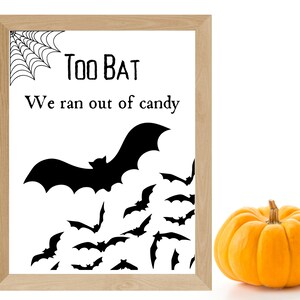 May include: A black and white printable sign with the text "Too Bat We ran out of candy" and a silhouette of a bat flying over a swarm of bats.