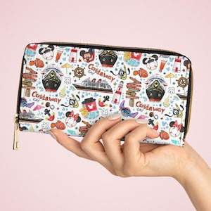 May include: A white zippered wallet with a colourful print of Disney characters and nautical themed designs. The print includes Mickey Mouse, Minnie Mouse, Stitch, and a cruise ship. The text "Castaway Cay" is repeated throughout the print.
