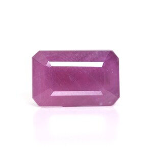 May include: A vibrant pink gemstone with a rectangular emerald cut.