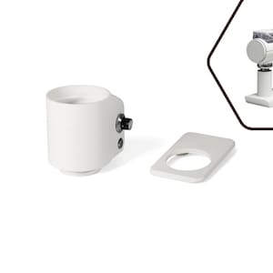 May include: White coffee machine with a cylindrical body, a black knob, and a rectangular base. A separate white rectangular piece with a circular cutout is also present. A smaller version of the machine is shown in the upper right corner.