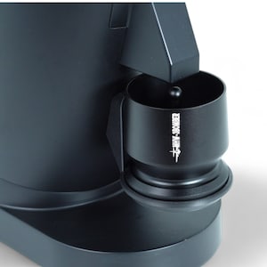 May include: Black coffee grinder with a removable black plastic cup that says "FHMY-SCOURER" on the side.