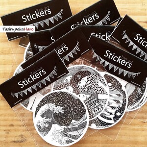 May include: A set of five black and white round stickers featuring various intricate designs. The stickers are packaged in a clear plastic bag with a black header that reads "Zen-art Stickers".