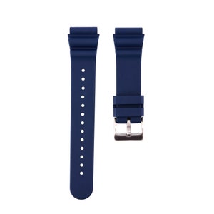 May include: A dark blue silicone watch strap with a silver buckle.