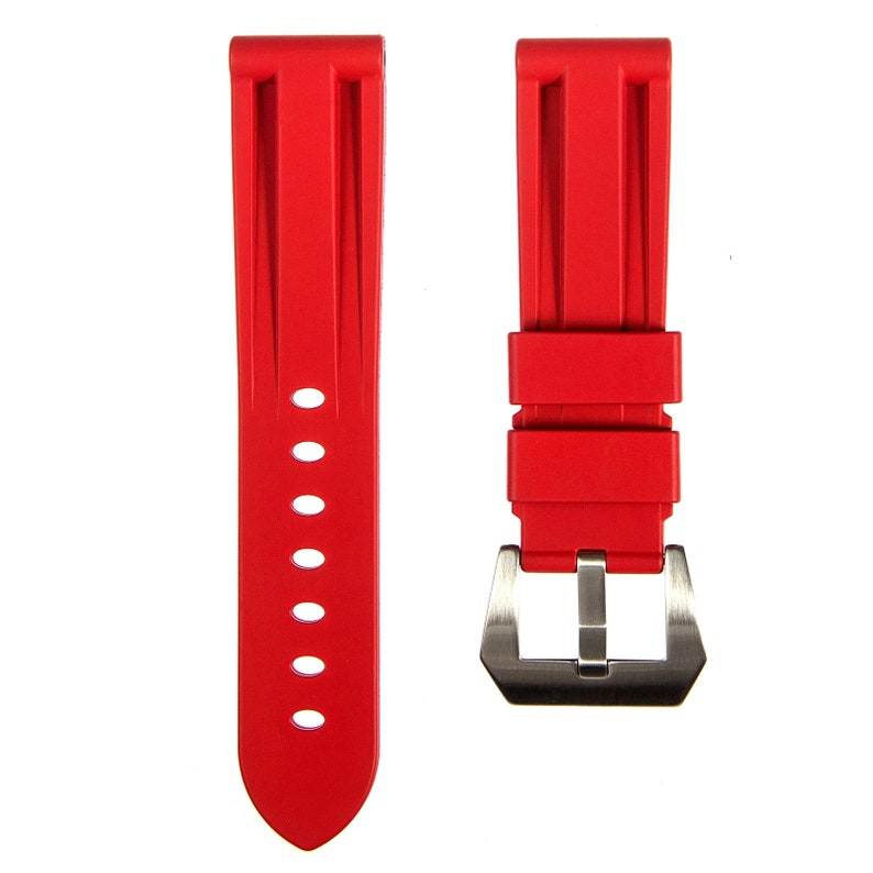 May include: Red rubber watch strap with a silver buckle.