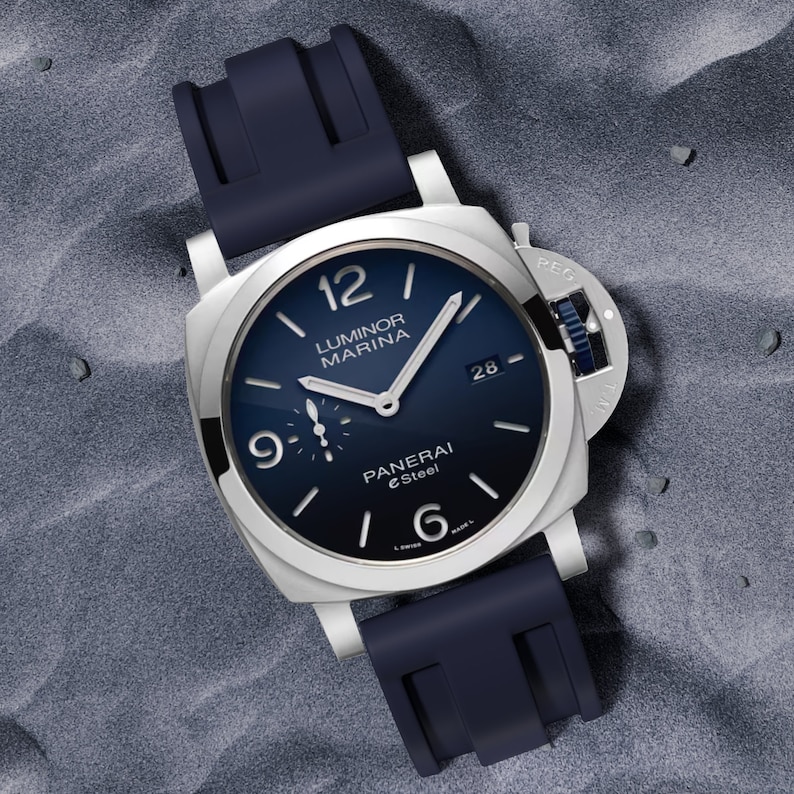 May include: A silver Panerai Luminor Marina watch with a blue face and black rubber strap. The watch face has silver hands and markers, and the words "Luminor Marina" and "Panerai eSteel" are printed on the face.