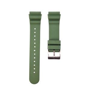May include: A green silicone watch strap with a silver buckle.