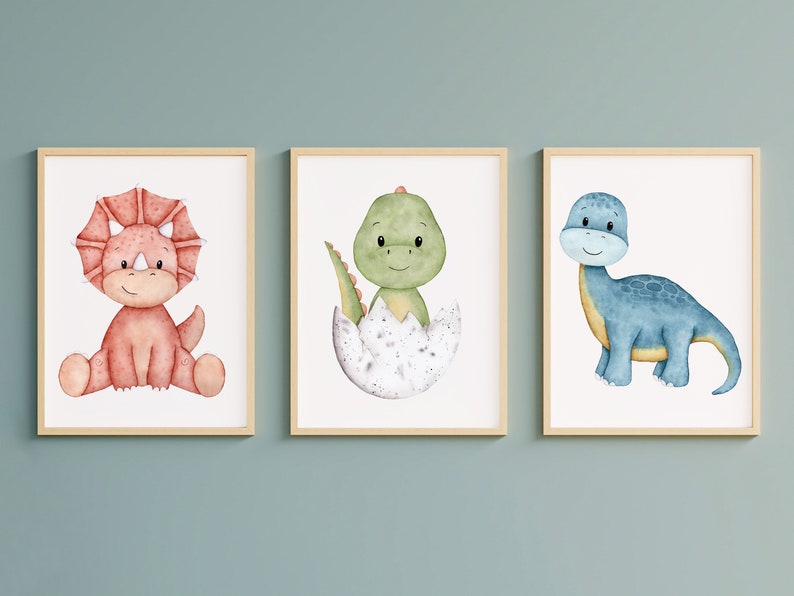 May include: Three framed watercolor illustrations of cute cartoon dinosaurs. The first dinosaur is red with three horns and is sitting down. The second dinosaur is green and is hatching from an egg. The third dinosaur is blue and is standing up.