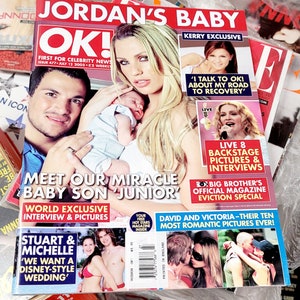 May include: A magazine cover featuring a photo of a couple holding their baby. The magazine is titled "OK!" and the headline reads "Meet Our Miracle Baby Son 'Junior'." The cover also features photos of celebrities Kerry Katona, David and Victoria Beckham, and Stuart and Michelle.
