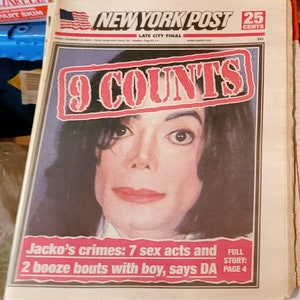 May include: A newspaper front page from the New York Post featuring a large image of Michael Jackson. The headline reads "9 COUNTS" in a red and white banner. Below, text details "Jacko's crimes: 7 sex acts and 2 booze bouts with boy, says DA."