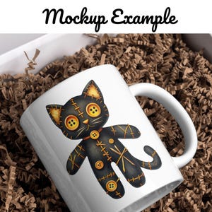 May include: White ceramic mug with a black and gold stitched cat illustration. The cat has large button eyes and a stitched-on collar. The mug is in a box with brown packing paper.