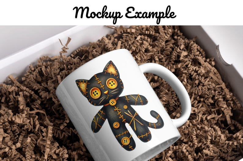 May include: White ceramic mug with a black and gold stitched cat illustration. The cat has large button eyes and a stitched-on collar. The mug is in a box with brown packing paper.