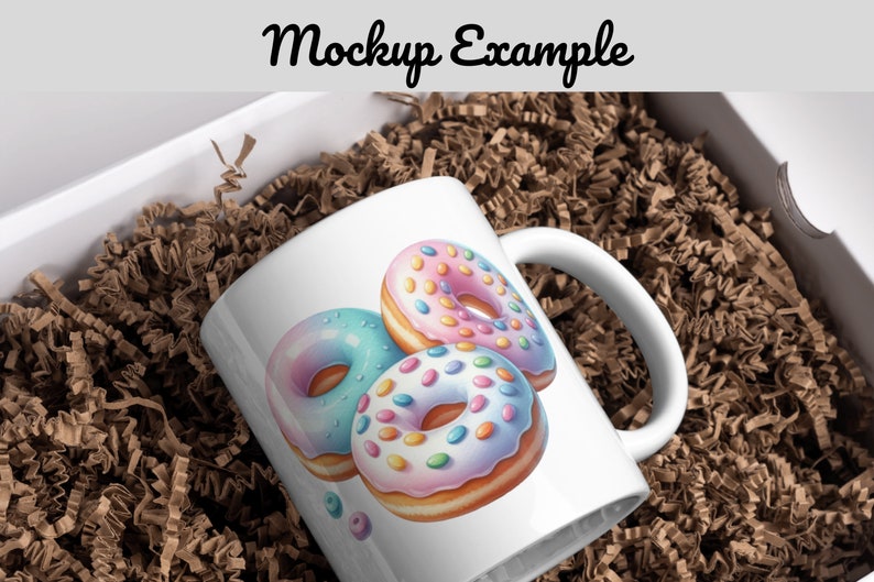Puede incluir: Taza de cer&aacute;mica blanca con un dise&ntilde;o de donut colorido. Las donas son rosadas, azules y blancas con chispas. La taza est&aacute; en una caja con papel de embalaje marr&oacute;n.