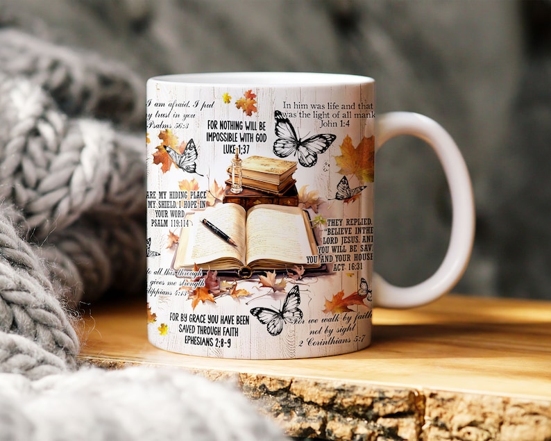 May include: White ceramic mug with a colorful design featuring butterflies, leaves, and bible verses. The text includes quotes such as "For nothing will be impossible with God" and "In him was life and that was the light of all mankind".