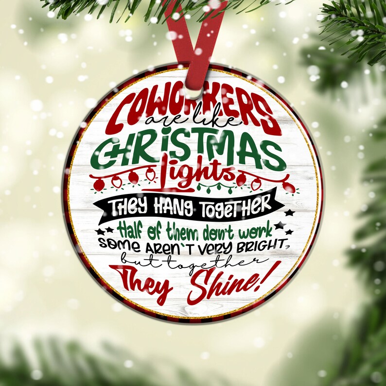 May include: Round white Christmas ornament with red and green text that reads "Coworkers are like Christmas lights. They hang together. Half of them don't work. Some aren't very bright, but together they shine!"