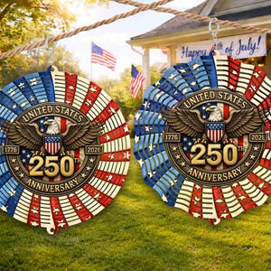 May include: Two circular wooden decorations with a patriotic theme. The decorations feature a red, white, and blue color scheme with the text "UNITED STATES 250TH ANNIVERSARY 1776-2026" and an eagle emblem. They are hanging outside on a rope.