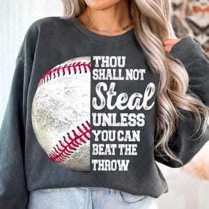 May include: A gray sweatshirt with a baseball graphic and the text "Thou shall not steal unless you can beat the throw."