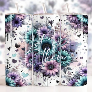 May include: Three stainless steel tumblers with a white background and a floral design. The tumblers have a teal and purple floral design with the words "Let Them" in the center.