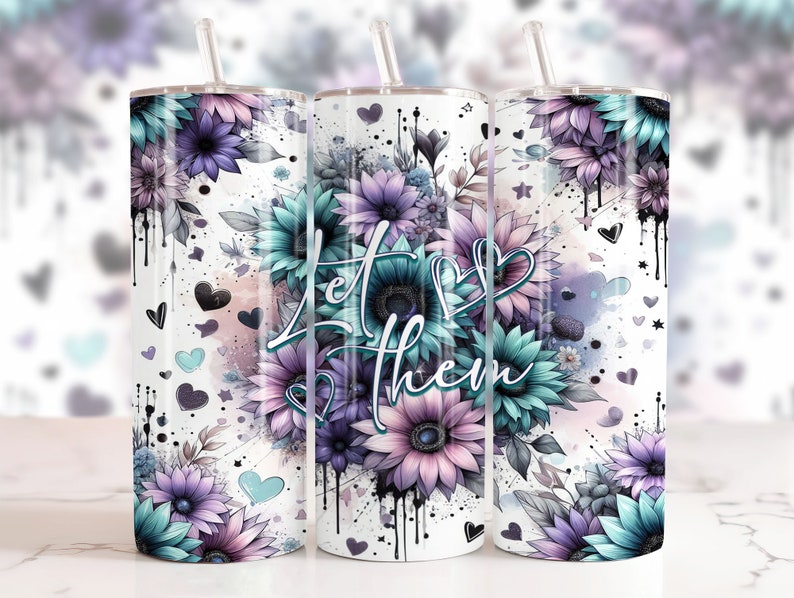 May include: Three stainless steel tumblers with a white background and a floral design. The tumblers have a teal and purple floral design with the words "Let Them" in the center.