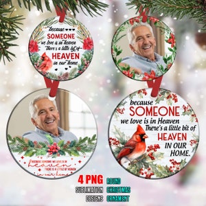 May include: Four round Christmas ornaments with a white background and red holly. Each ornament features a cardinal bird and the text "because someone we love is in heaven there's a little bit of heaven in our home". Two of the ornaments have a photo of a man in the center.