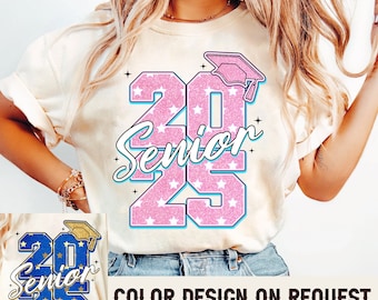 May include: A white t-shirt with a pink glitter design that says "Senior 2025" with a graduation cap on top of the 2. The design has white stars on a pink background with a blue outline.