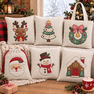 May include: A collection of cream-colored fabric items featuring embroidered Christmas designs including a reindeer, a tree, a wreath on a tote bag, a Santa Claus drawstring bag, a snowman, and a gingerbread house, all with festive red and green accents.