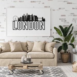 May include: A black and white illustration of the London skyline with the word "LONDON" in bold letters below. The illustration is framed and hanging on a white brick wall above a beige sofa.