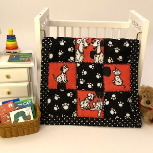 May include: A miniature crib with a black and white Dalmatian-themed quilt. The quilt features red squares with Dalmatian illustrations. A small teddy bear, books, and a lamp are also visible.