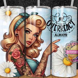 May include: A blue and white tumbler with a cartoon image of a woman with blonde hair and a tattoo on her arm. The text "I me overreact always" is on the tumbler.