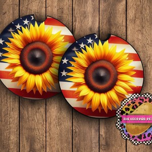 May include: Two round coasters with a sunflower design on a red, white, and blue American flag background. The coasters are on a wooden surface. The text "THE LEOPARD POTATO" is on a round sticker with a leopard print design.