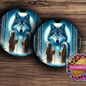 Puede incluir: Dos figuras nativas americanas se encuentran en un bosque con una cabeza de lobo en el fondo. La cabeza del lobo está iluminada por una luna llena. Las figuras sostienen bastones y un atrapasueños. El fondo es azul oscuro con árboles blancos.