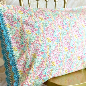 Handmade crochet trim floral pillowcase. Pretty white pink turquoise yellow fabric, blue organic linen crocheted knit edge pillow case sham