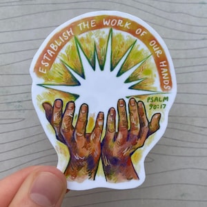 May include: A sticker featuring a yellow, orange, and green sunburst design. Two hands are raised in the centre of the sunburst. The text around the sunburst reads "Establish the work of our hands" and "Psalm 90:17".