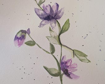 May include: Watercolor painting of delicate purple flowers with green leaves on a white background. The flowers are in various stages of bloom, with one bud and two open blossoms. Black ink splatters add a decorative touch.