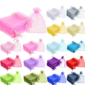 May include: A set of 100 small, sheer organza bags in various colors, including pink, yellow, blue, purple, green, and red. The bags are made of a delicate, translucent fabric and have a drawstring closure.