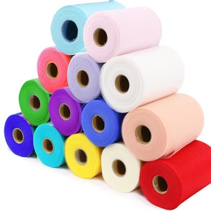 May include: A collection of 12 rolls of tulle fabric in various colours, including red, pink, blue, green, yellow, and white. The rolls are arranged in a pyramid shape.