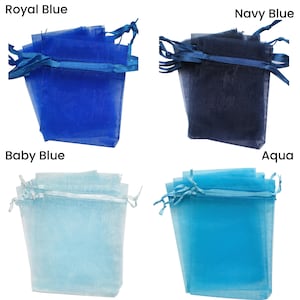 May include: Four organza bags in different shades of blue: royal blue, navy blue, baby blue, and aqua. The bags are made of sheer fabric and have a drawstring closure.