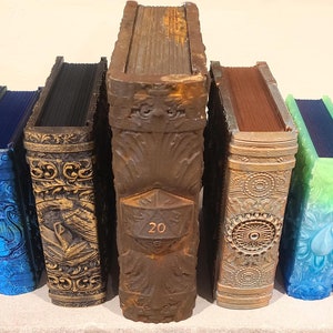 May include: A row of ten decorative books with intricate designs and various colors, including purple, blue, green, and brown. The book in the center has the number "20" on the front cover.