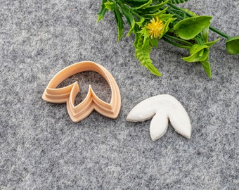 Peut inclure: Deux emportes-pièces en plastique en forme de fleur. L'emporte-pièce de gauche est beige et celui de droite est blanc.