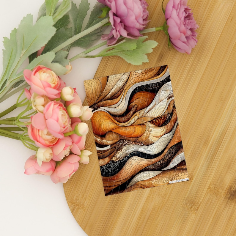 May include: A rectangular print featuring an abstract pattern of flowing, wavy lines in shades of brown, tan, cream, and black, with intricate stippled textures. The print is displayed alongside a cluster of pink artificial flowers.