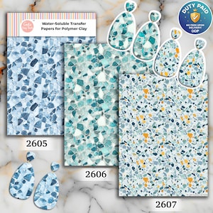 May include: Three sheets of water-soluble transfer paper for polymer clay labeled 2605, 2606, and 2607, featuring blue, teal, and yellow mosaic patterns. The set includes matching teardrop-shaped earrings displaying the same stone-like designs.