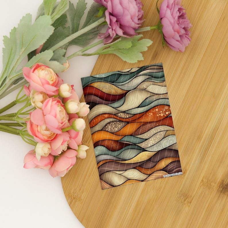 May include: A rectangular card featuring an abstract pattern of flowing, wavy lines in shades of teal, burnt orange, cream, and brown. The design includes intricate textures and dotted details within the waves, accompanied by pink artificial flowers.
